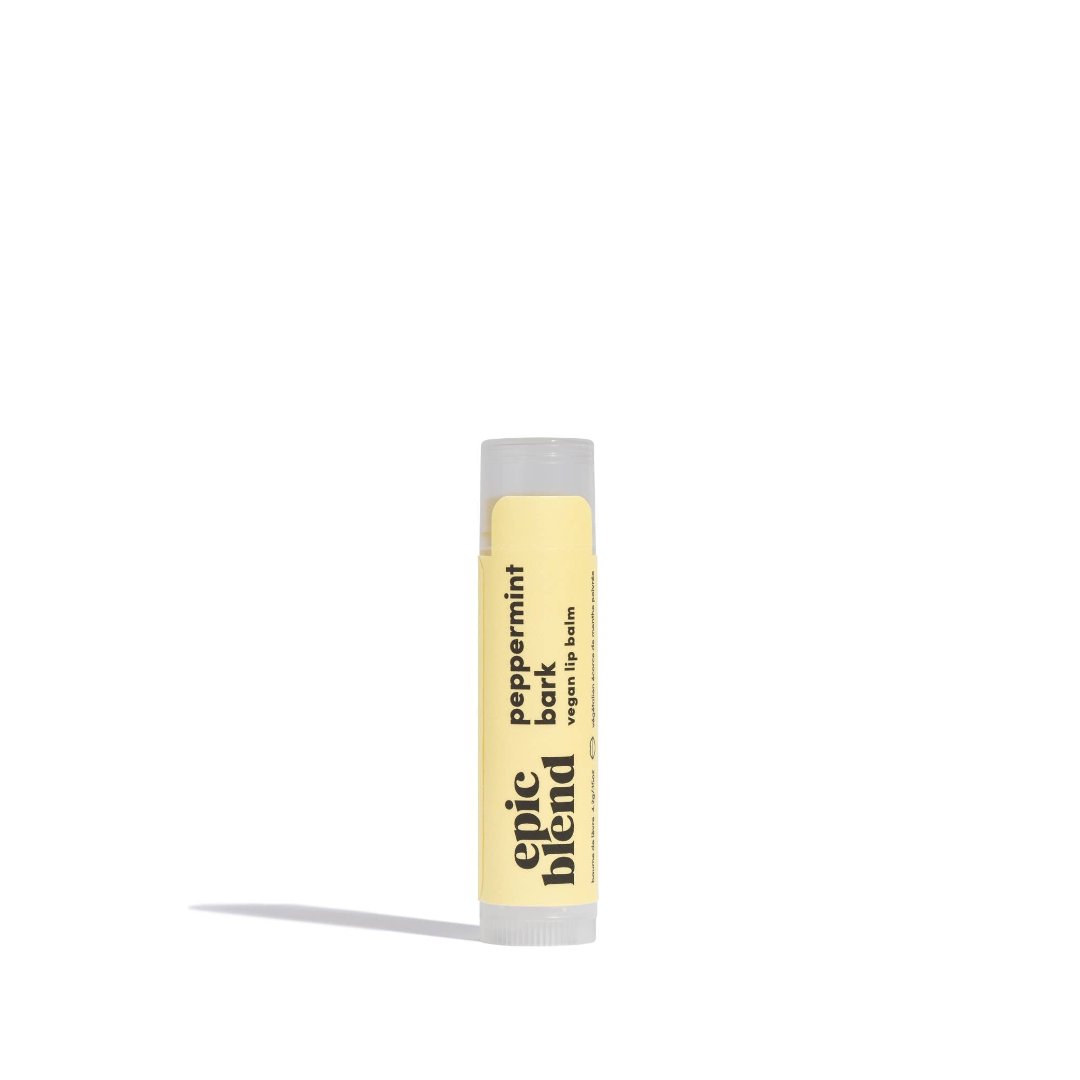 A yellow tube of Epic Blend Peppermint Bark Vegan Lip Balm. The label on the tube features the product name and indicates that it is vegan.