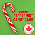 Handmade peppermint candy cane with red text and a Canadian flag logo on a green background