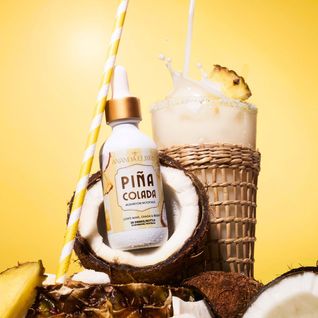 Piá Colada bottle with a cocktail and coconut on a yellow background