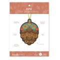 Kiriku {felt} Pine felt ornament kit by Kiriku Fabrics, featuring a felt pinecone ornament on its original packaging card.