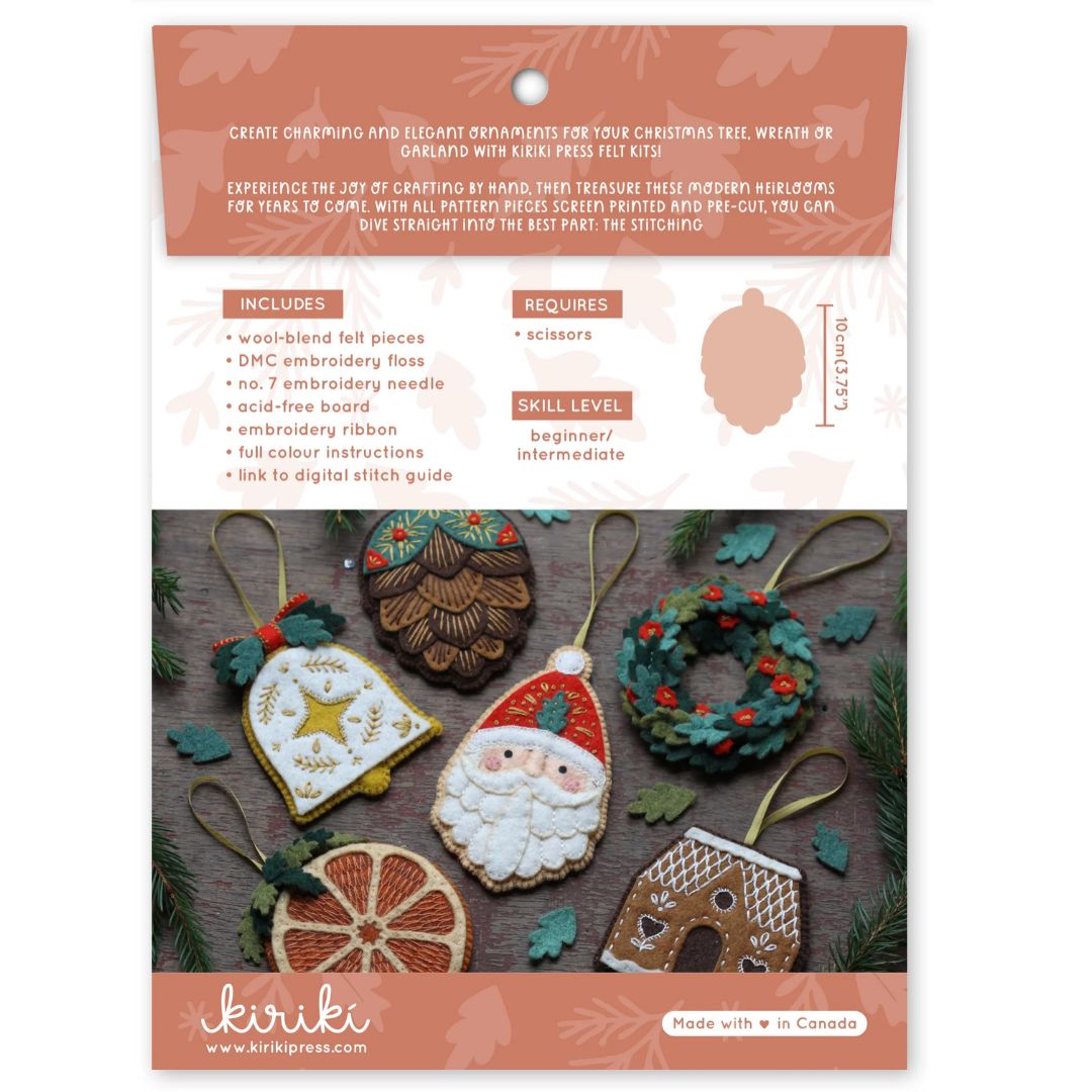Kirkie Christmas ornament embroidery kit in its original packaging, featuring a peach and white card with product details, a size diagram, and photos of completed embroidered ornaments including Santa Claus, a gingerbread man, and a pinecone ornament.
