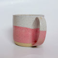 Valerie Daoust Ceramics Pink Dipped Mug, a handmade ceramic mug with a colorblock design featuring a light gray top and a speckled pink middle section, displayed on a light gray background. The mug has a large, rounded handle, a speckled texture, and is made in Mississippi Mills, Ontario, Canada.