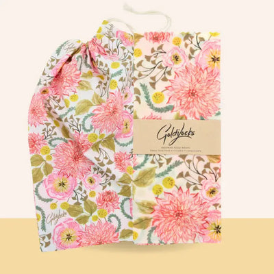 Floral-patterned product packaging with 'Goldfuchs' branding on a beige background