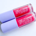 Two tubes of GLOSS by MIMI Pink Papaya Lip Gloss with lavender caps and vibrant pink shimmer gloss inside, displayed for branding and product showcase.