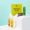 A set of four Epic Blend vegan lip balms in a yellow box. The lip balms are in different colors and flavors: peach, pineapple mint, wild berry, and coconut lemon. The box has the text 