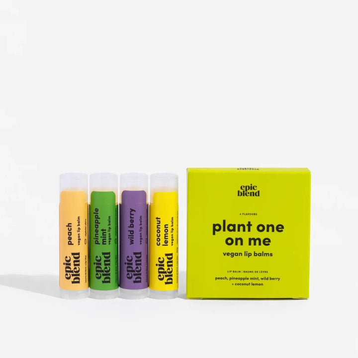 A set of four Epic Blend vegan lip balms in a yellow box. The lip balms are in different colors and flavors: peach, pineapple mint, wild berry, and coconut lemon. The box has the text 