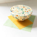 Reusable food container with floral pattern on a white surface