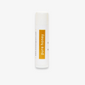 A white tube of lip balm with the word "pure honey" printed in yellow on the label.