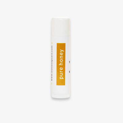 A white tube of lip balm with the word 