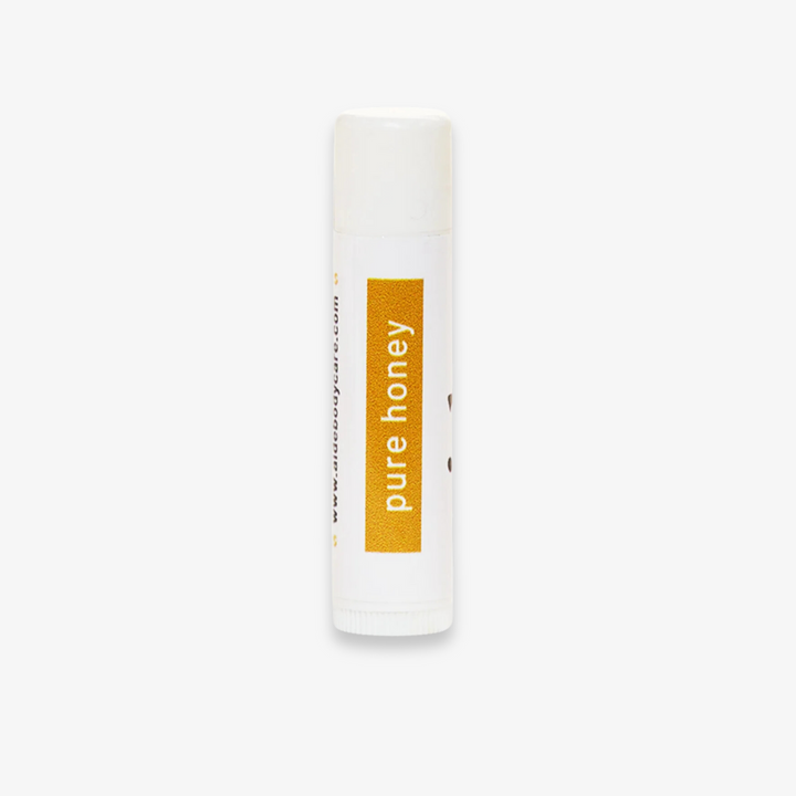 A white tube of lip balm with the word 