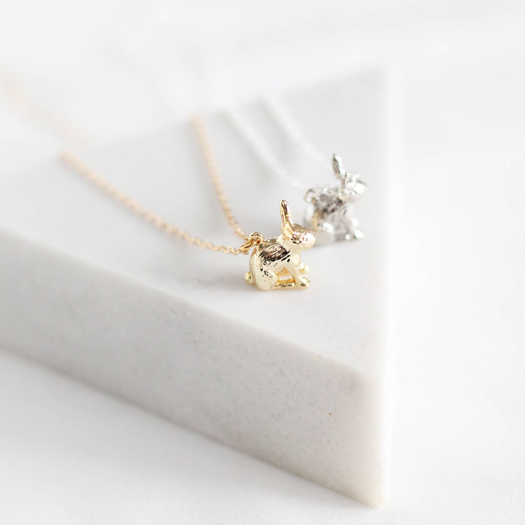 Gold and silver necklace on a white surface