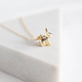 Gold bunny pendant necklace on a white background