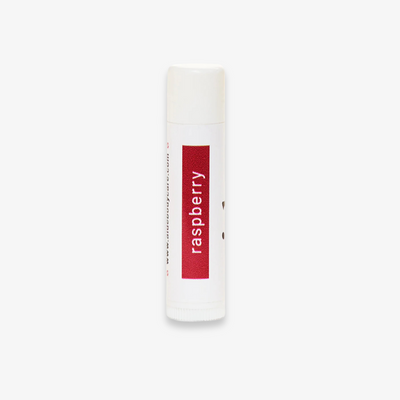 A white tube of lip balm with the word 