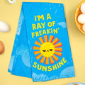 Blue towel with sun design and text on a yellow background