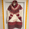 Quilted jacket with geometric pattern hanging on a door