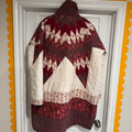 Quilt with red and white pattern hanging on a door