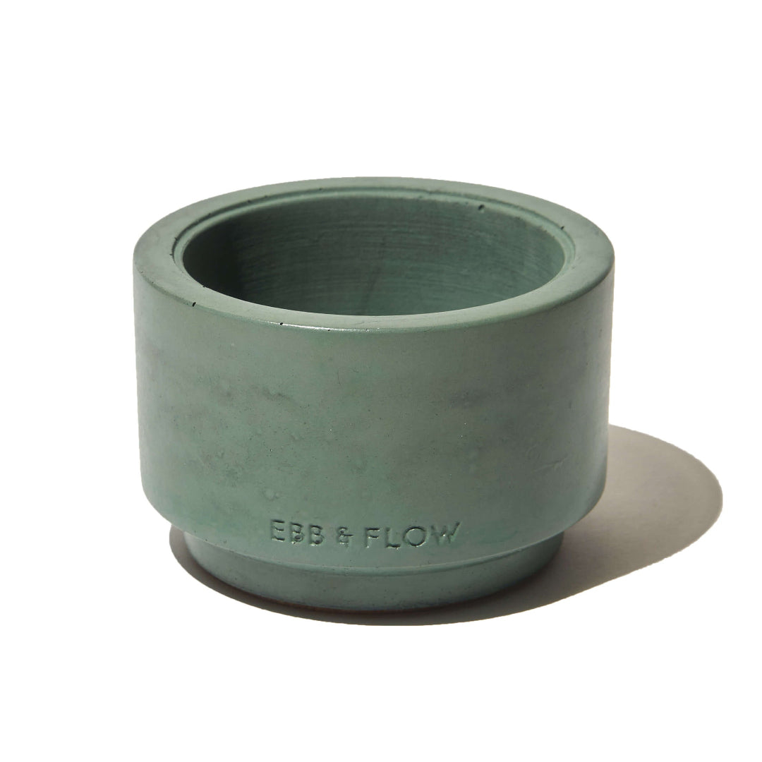 Green concrete planter with 'Ebb & Flow' branding on a white background