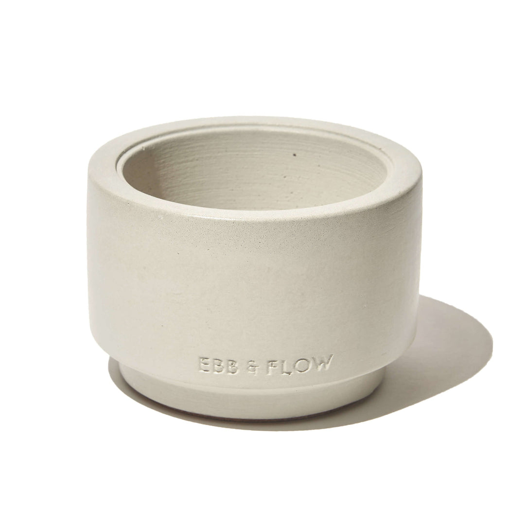 Beige ceramic planter with 'Ebb & Flow' branding on a white background