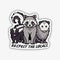 A whimsical sticker featuring three cartoon nocturnal animals: a small skunk, a larger raccoon in the center, and an opossum on the right. Below them, the text 