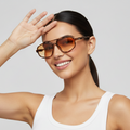 Woman wearing sunglasses with a neutral background