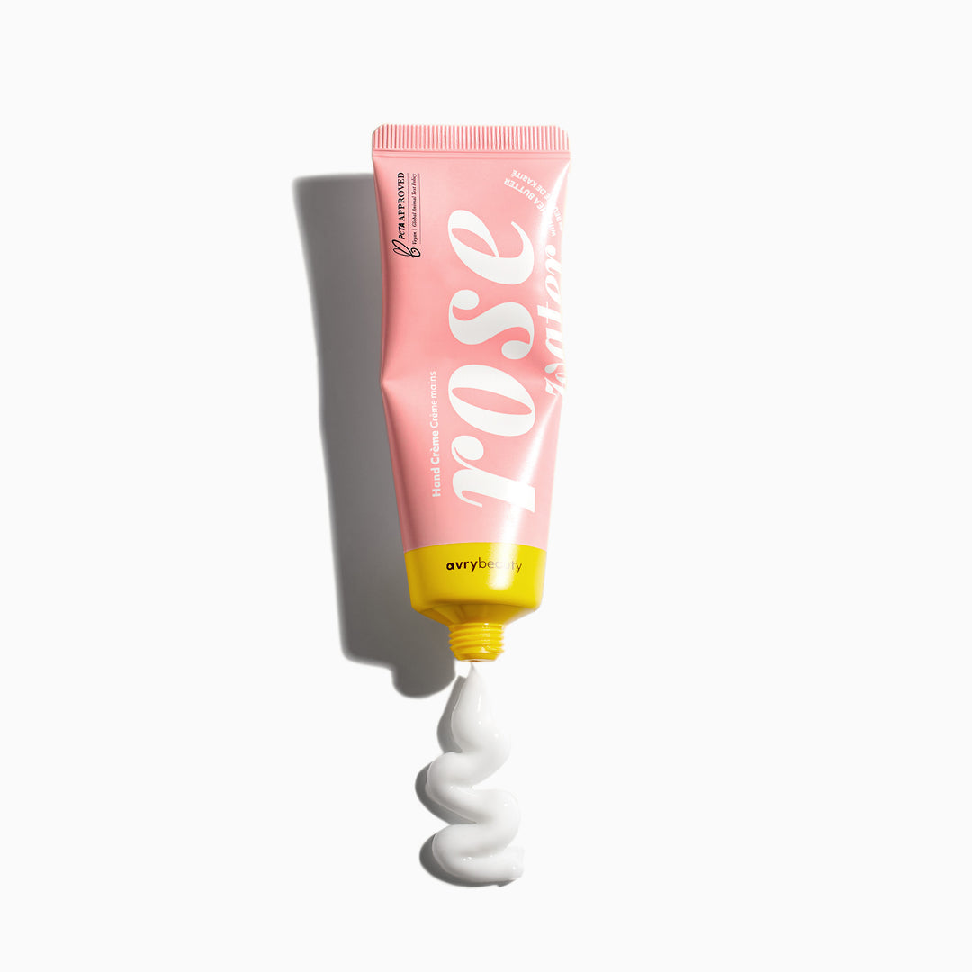 Pink tube of cream with white swirl on a white background