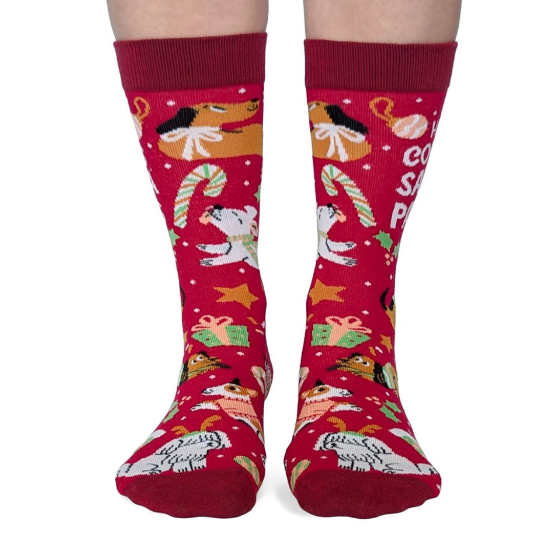 Red Christmas-themed socks with festive designs on a white background