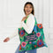A green tote bag with a floral pattern. The text 