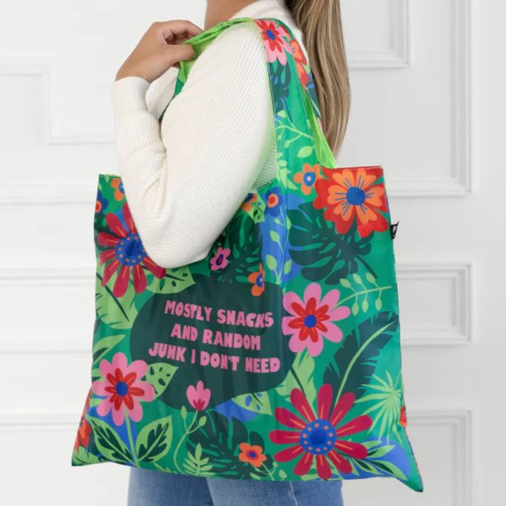 A green tote bag with a floral pattern. The text 