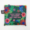 A green tote bag with a floral pattern. The text 