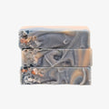 Three bars of soap with a marbled design on a white background