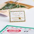 A gold-colored pin shaped like a Christmas list. The list has a slider that can be moved between "NAUGHTY" and "NICE." A star is placed on the slider.