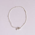 Silver bracelet on a light gray background
