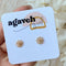 A pair of gold daisy stud earrings on a white background. The earrings have a delicate, openwork design with a small circle in the center of each flower.