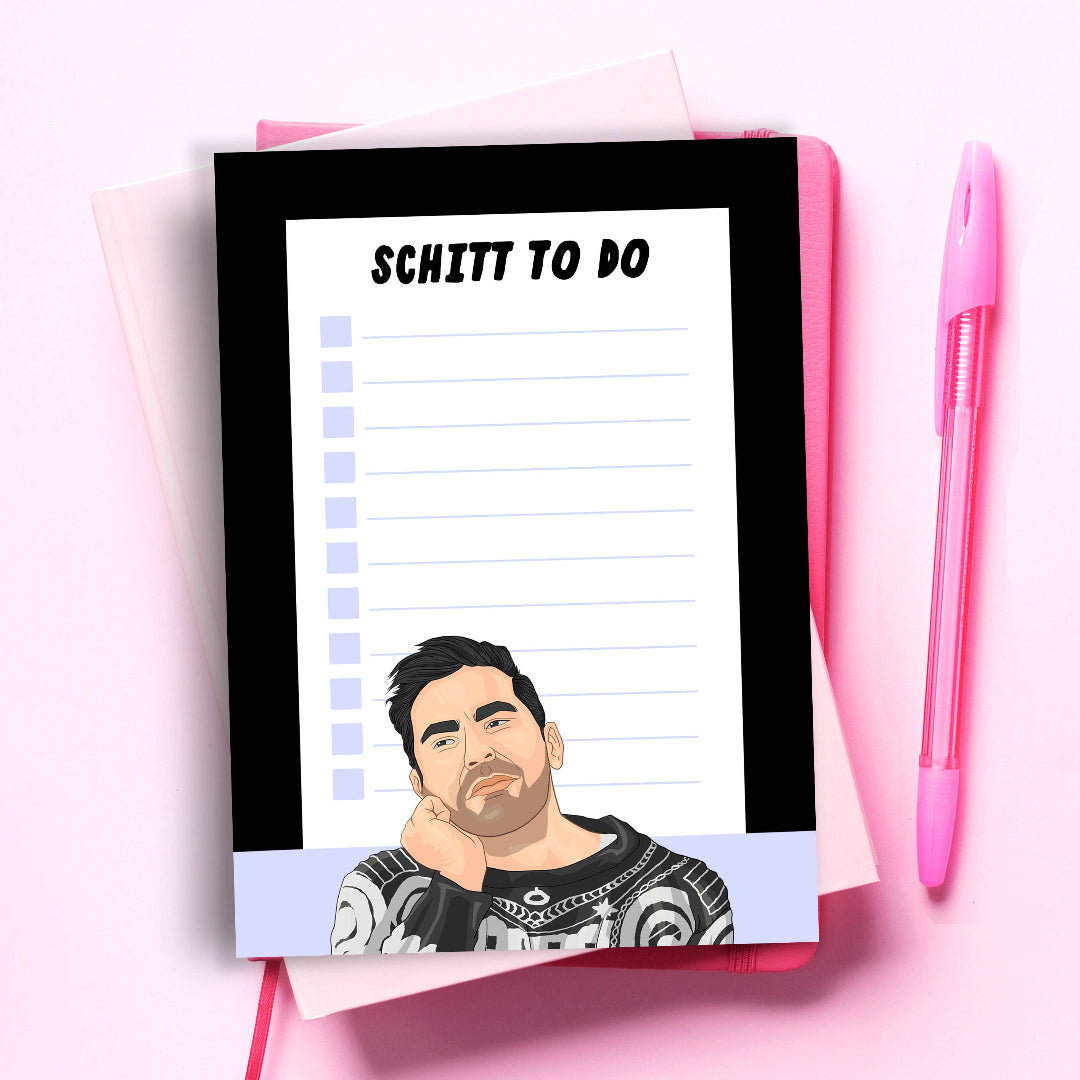 Notepad with 'Schitt to Do' text and cartoon character on a pink background