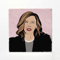 A square art print or coaster featuring a stylized illustrated portrait of a woman with brown hair, red lips, a black jacket, gray top, and white pearl necklace against a pale pink background, shown on a white surface.