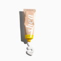 Shea butter tube with a white cream swirl on a white background