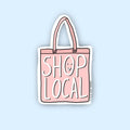 A pink sticker shaped like a tote bag with the text "SHOP LOCAL" in white and a small smiley face. The text "LITTLE MAY PAPERY" appears in smaller print at the bottom.