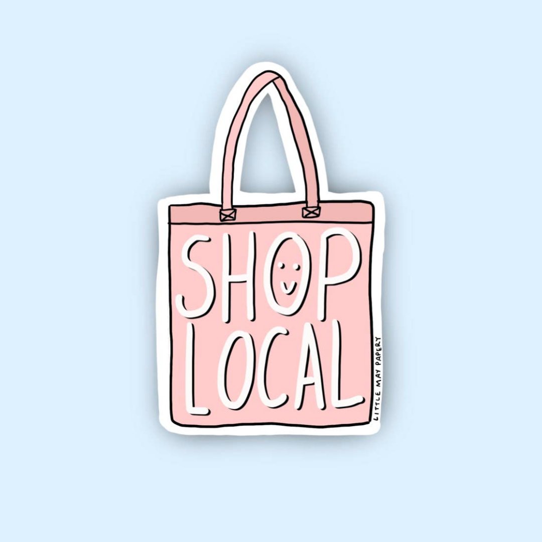 A pink sticker shaped like a tote bag with the text "SHOP LOCAL" in white and a small smiley face. The text "LITTLE MAY PAPERY" appears in smaller print at the bottom.