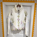 Floral-patterned jacket hanging on a door with decorative yellow border