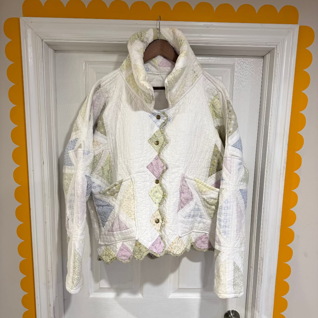 Floral-patterned jacket hanging on a door with decorative yellow border