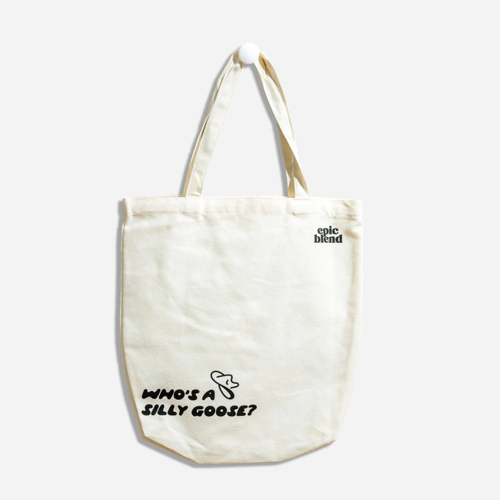 A white tote bag with a black illustration of a goose wearing a cowboy hat. The text 