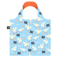 A reusable tote bag with a light blue background and an all-over print of white silly geese, orange beaks and feet, and black 'SILLY GOOSE' text. The bag has a bright orange handle and a small black square tag on the left side.