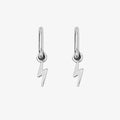 A pair of silver earrings with lightning bolt charms on a pink background. The earrings are displayed on a card with the brand name "Foxy Originals."