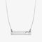 A silver necklace with a bar pendant. The bar has a cut-out maple leaf design.