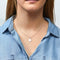 A silver necklace with a maple leaf pendant.
