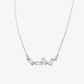 A silver necklace with several rectangular-shaped crystals on a pink card with the brand name "Foxy Originals."