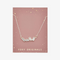 A silver necklace with several rectangular-shaped crystals on a pink card with the brand name 