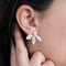 A pair of silver leaf earrings with detachable ear jackets. The earrings feature three overlapping leaf-shaped designs with a small pearl in the center of each leaf. 