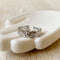 A silver Malta ring, featuring a textured, organic design, displayed on a white, hand-shaped jewelry holder. The ring is an open, adjustable style, available in Ottawa, Ontario, Canada.