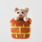 A felt ornament of a cat peeking out of a chimney.